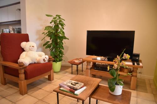 a living room with a teddy bear sitting on a chair at RectoVersoVV in Sint-Pieters-Leeuw