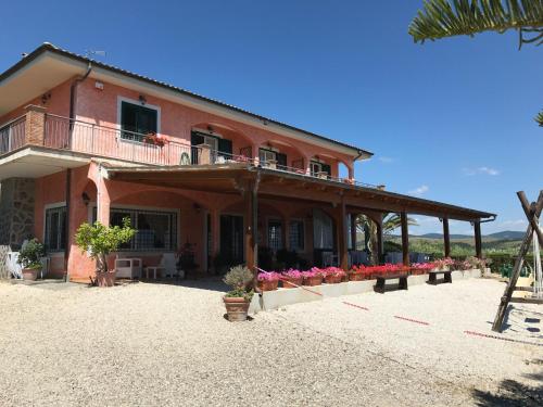 a house with flowers in front of it at I Cardinali in Santa Marinella