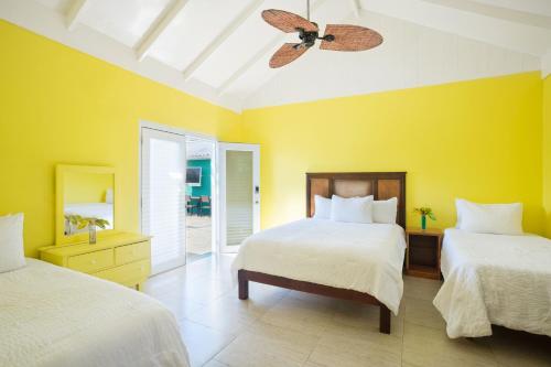 a bedroom with two beds and a ceiling fan at Luna Sea Inn in Bluefields