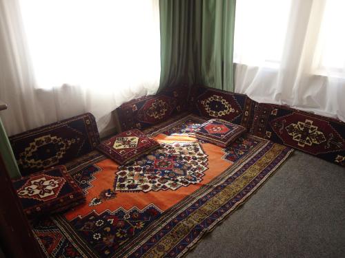 a group of pillows sitting on a couch in front of a window at Akar Hotel in Ihlara