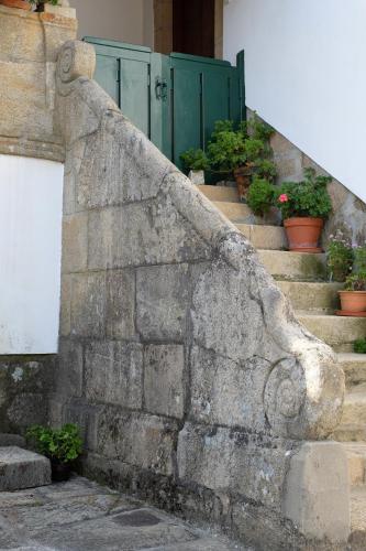 a stone retaining wall with potted plants on the stairs at Quinta da Calçada in Melgaço