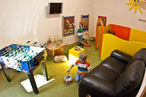 two young children playing in a play room at AlpinApart Bacher in Serfaus