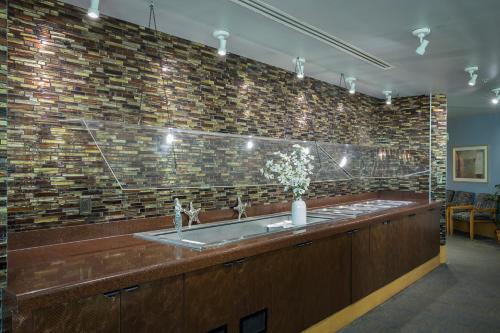 a bathroom with a sink and a brick wall at Avista Resort in Myrtle Beach