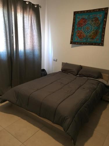 a large bed in a bedroom with a window at New cozy flat with pool in amazing place..! in Costa Del Silencio