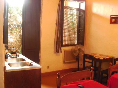 a kitchen with a sink and a window at Panambi in Asunción