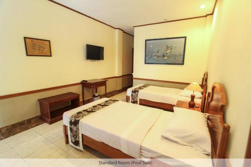 Кровать или кровати в номере Duta Guest House