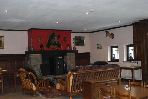 布永的住宿－樂凱迪歐爾酒店，客厅设有壁炉、沙发和椅子