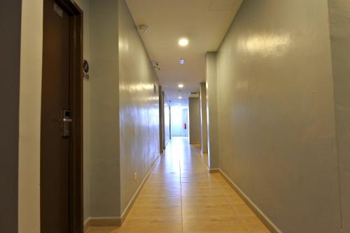 an empty hallway with a long corridor at Hotel Dutaria in Ipoh
