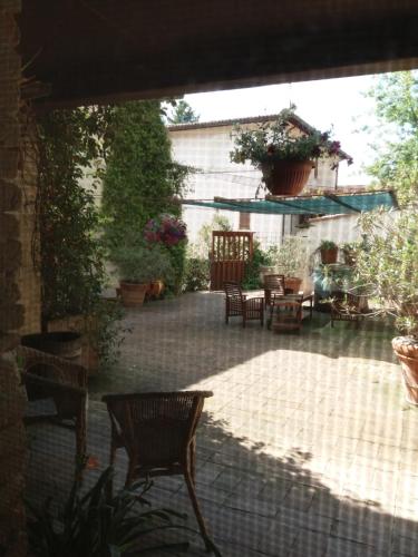 an outdoor patio with chairs and tables and plants at B&B Casa Zia Cianetta Residenza di Campagna in Capodacqua di Foligno