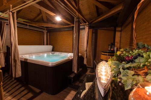 a bathroom with a tub and a table with fruits and vegetables at Apartments Maslina in Crikvenica