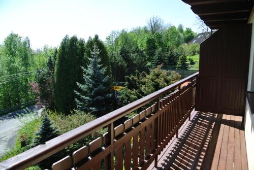 a balcony of a house with a view of trees at Pension Imlauf in Vrchlabí