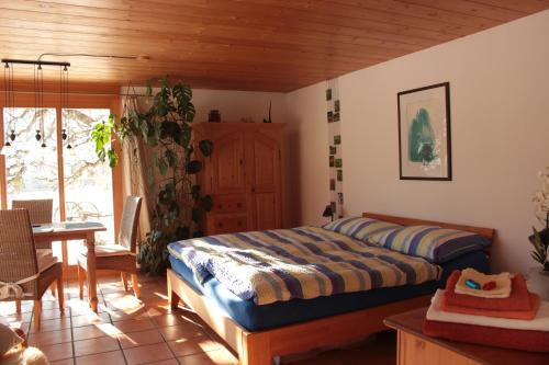 ein Schlafzimmer mit einem Bett und ein Esszimmer mit einem Tisch in der Unterkunft Dunkel Blaue Maus in Meiringen