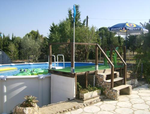 a swimming pool with a slide and a swimming pool at Finca Gamundi in L'Ampolla