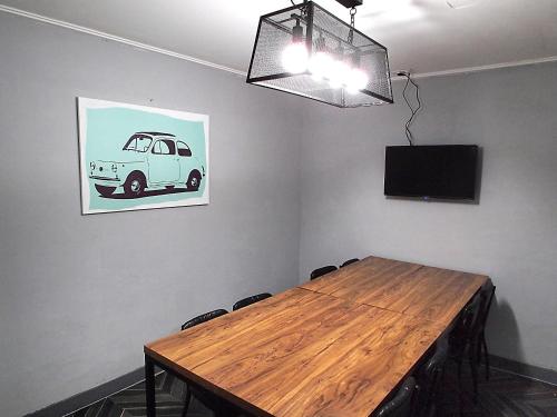 a conference room with a wooden table and a tv at Hotel Park Hill Myeongdong in Seoul