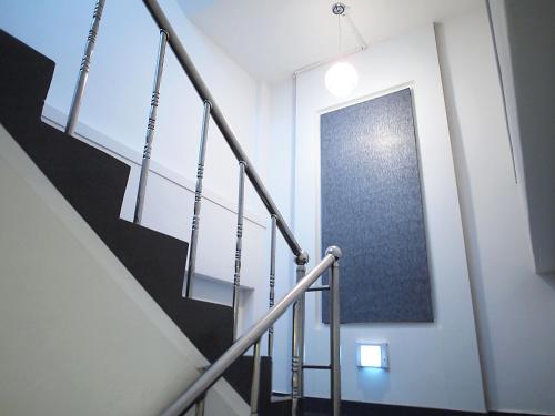 a staircase in a building with a glass door at Hotel Park Hill Myeongdong in Seoul