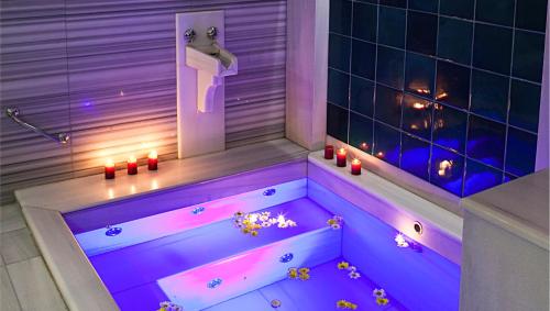a bath tub with purple lighting in a bathroom at Kitapevi Hotel in Bursa