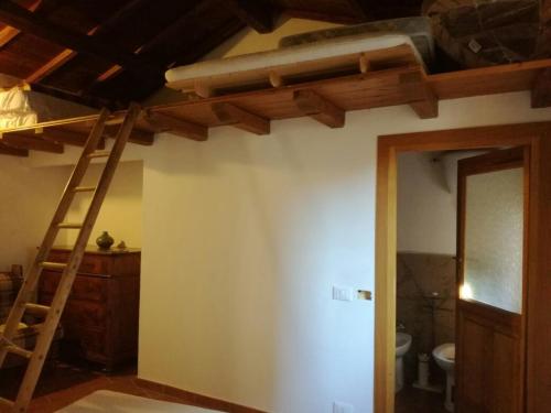 a room with a bunk bed and a ladder at Casamatta a Blera in Blera