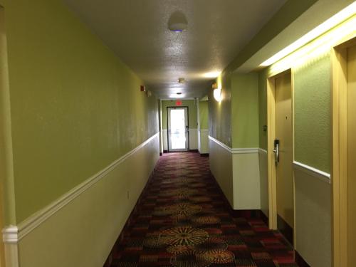 an empty hallway with green walls and a hallway with a door at Super 8 by Wyndham Dandridge in Dandridge