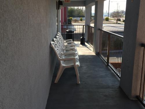 a row of white chairs sitting on a balcony at Super 8 by Wyndham Dandridge in Dandridge