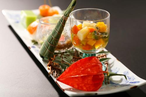 a plate of food with a wine glass on a table at Sansuisou in Hakone