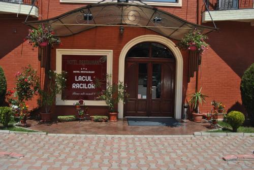 a front door of a brick building with plants at Lacul Racilor in Olimp