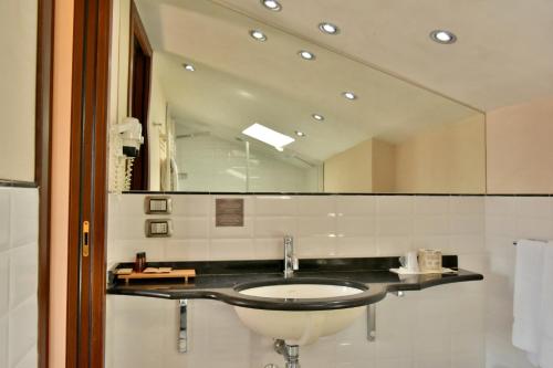 a bathroom with a sink and a mirror at Bosone Palace in Gubbio
