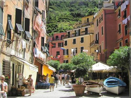 a group of people walking down a street with buildings at Cegi's home in Vernazza