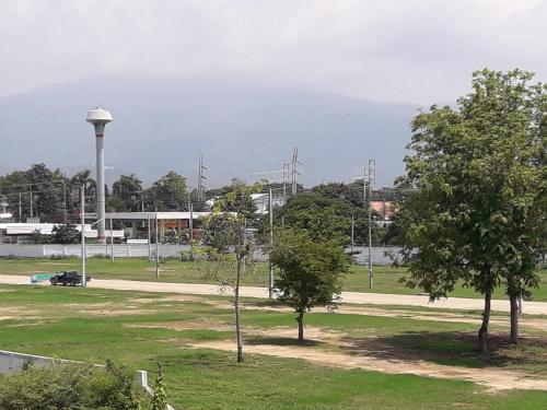 a park with two trees and a street light at New Loft Modern Home in Hang Dong