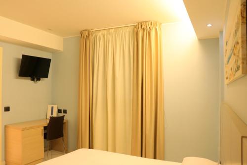 TV a/nebo společenská místnost v ubytování Hotel Ancora
