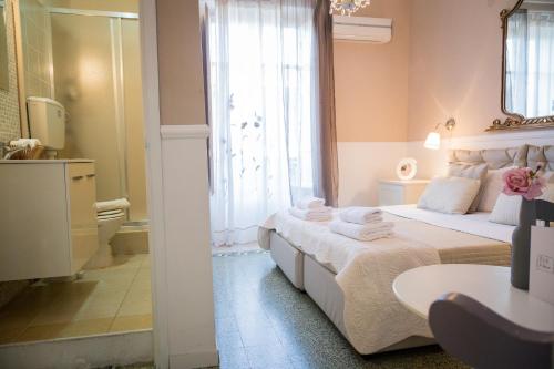 a bedroom with a large bed and a bathroom at B&B Abbacò in Palermo