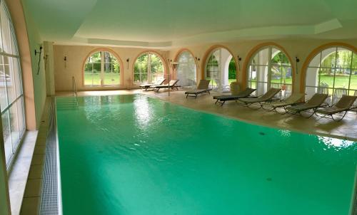a large swimming pool with chairs in a building at Seeresidenz Gesundbrunn in Plau am See