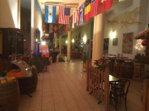 a restaurant with flags hanging from the ceilings and a hallway at Résidence "Les Crêtes" in Torgon