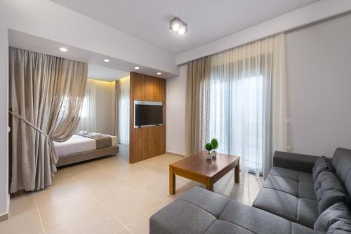 a living room with a couch and a bed at Lardos Luxury Apartments in Lardos