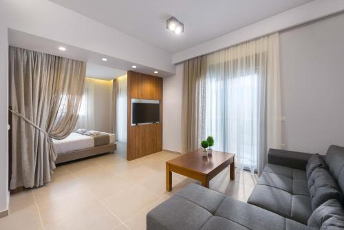 a living room with a couch and a bed at Lardos Luxury Apartments in Lartos