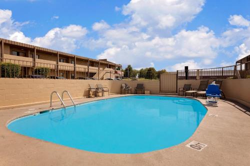 a large swimming pool in front of a hotel at Knights Inn Page in Page