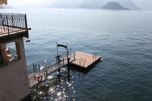 a dock in the middle of a large body of water at Casa Du Lac, by R Collection Hotels in Varenna