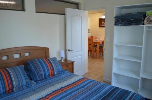 a bedroom with a bed and a dining room at Piedra Negra in Papudo