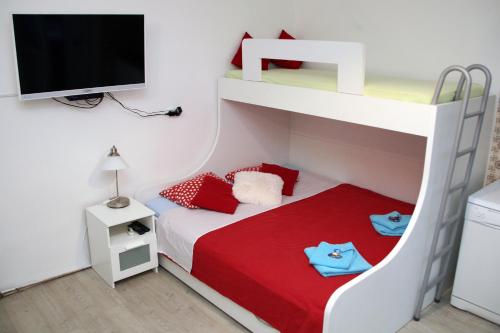 a childs bedroom with a bunk bed and a television at Villa Lole in Split