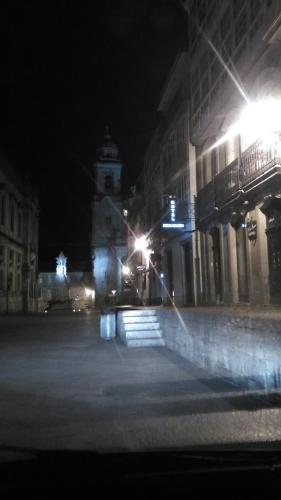 a building with a clock tower at night at PICO SACRO II HOTEL Santiago de Compostela in Santiago de Compostela