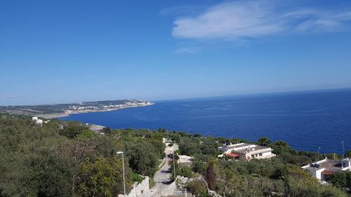 a view of the ocean from a hill with houses at Casa Bellavista in Castro di Lecce