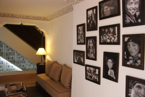 a living room with black and white pictures on the wall at Riad Celia in Marrakech