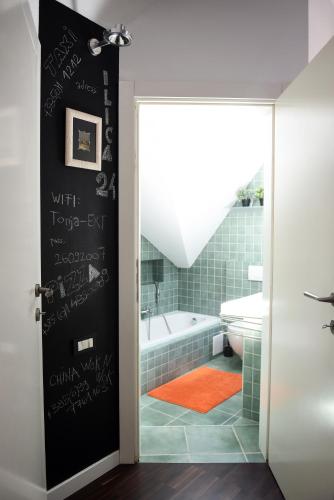 a bathroom with a bath tub and a toilet at Zagreb Rooftops in Zagreb