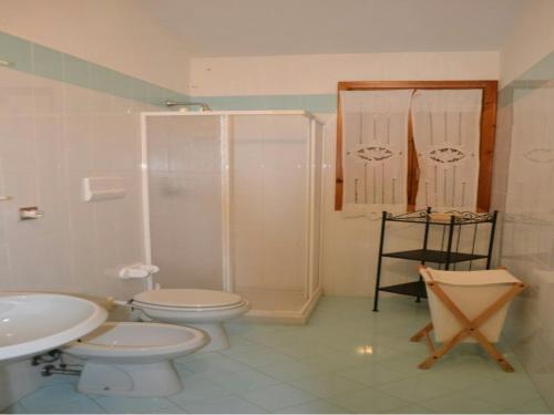 a bathroom with a shower and a toilet and a sink at Casa Asparagi in San Teodoro