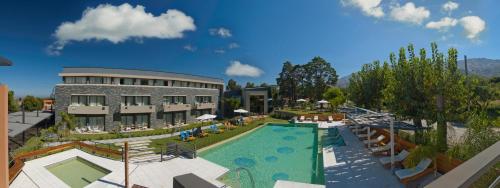 a resort with a swimming pool and a building at Altos De Merlo Suites in Merlo
