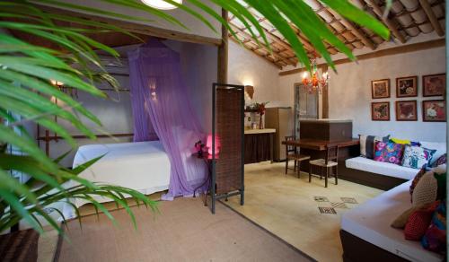 a bedroom with a bed and a desk and a mirror at Casas da Vila in Trancoso