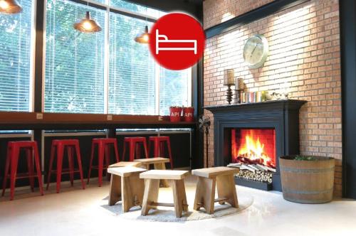 a room with a fireplace and stools and a fire place at The Bed KLCC in Kuala Lumpur