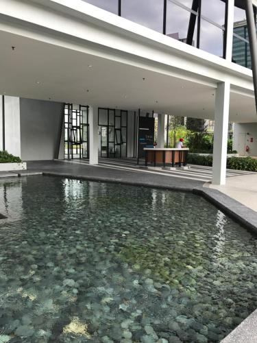 a pool of water in front of a building at Hyve Cyber Bistari in Cyberjaya