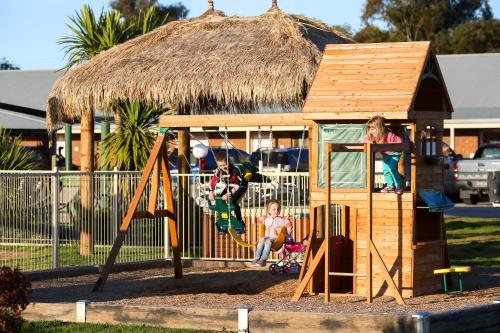 two children playing on a playground in a hut at Howlong Golf Resort in Howlong