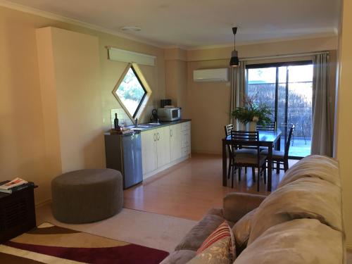 a living room with a couch and a table at The Rocks Apartments in Halls Gap