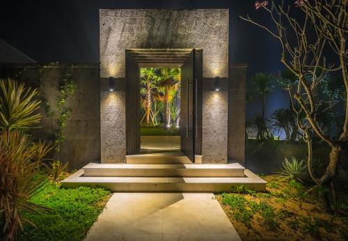 a entrance to a building with a door and stairs at The Edge Bali in Uluwatu